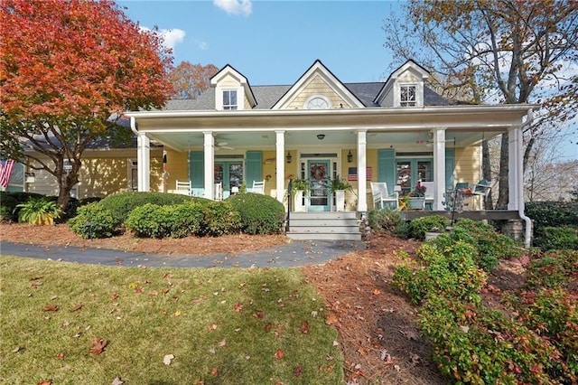 view of front of house with a porch and a front yard