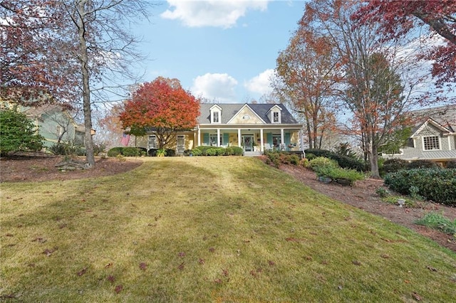 cape cod-style house featuring covered porch and a front lawn