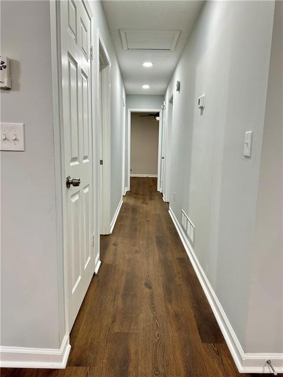 hallway with dark hardwood / wood-style flooring