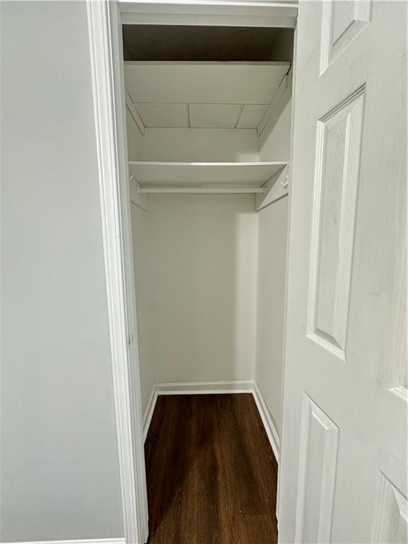 walk in closet featuring dark wood-type flooring