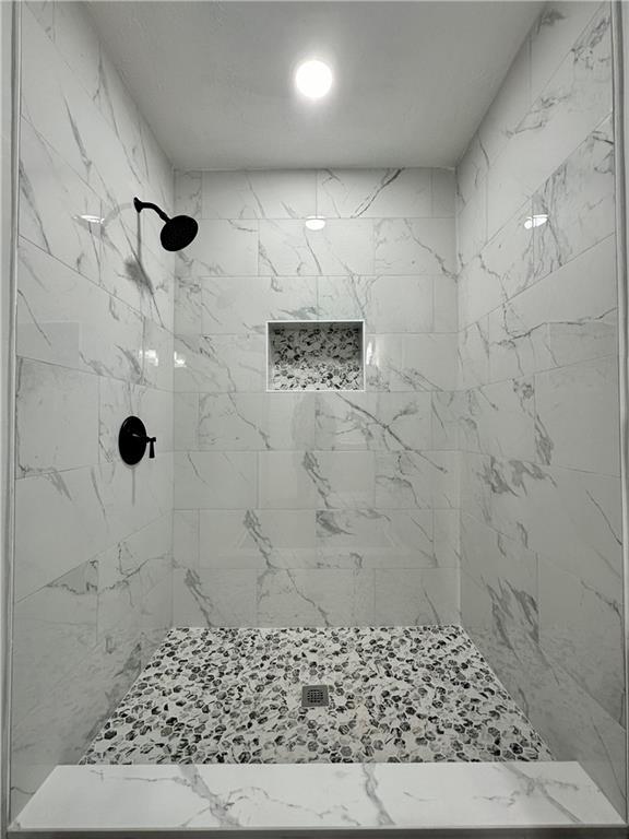 bathroom with tiled shower