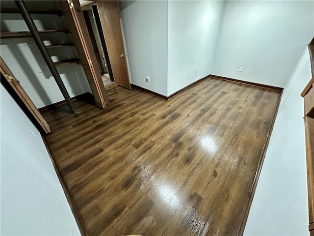 unfurnished room featuring dark hardwood / wood-style flooring