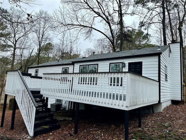 rear view of property featuring central AC unit and a deck