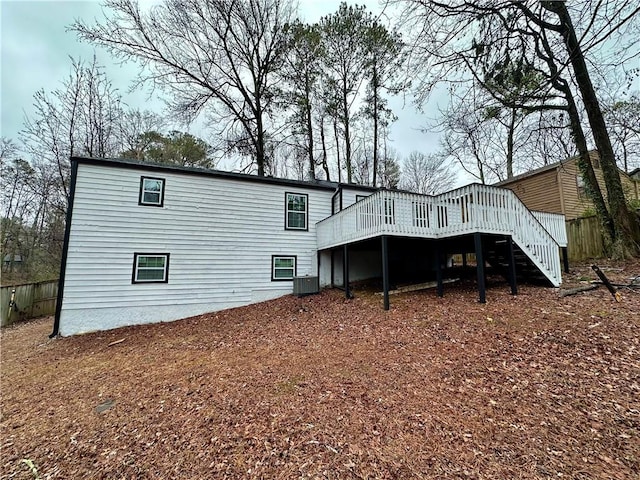 back of property with cooling unit and a deck