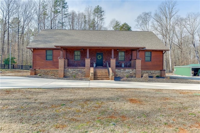 view of front of home featuring a front yard and a porch