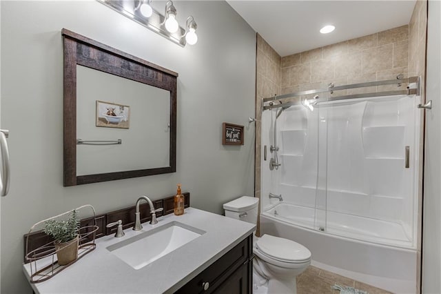 full bathroom featuring vanity, tile patterned flooring, shower / bath combination with glass door, and toilet