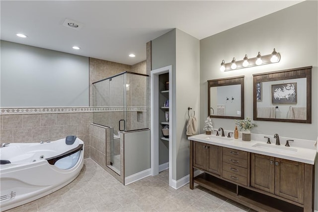 bathroom with tile patterned flooring, vanity, and separate shower and tub