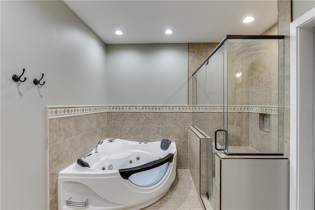 bathroom with plus walk in shower and tile walls