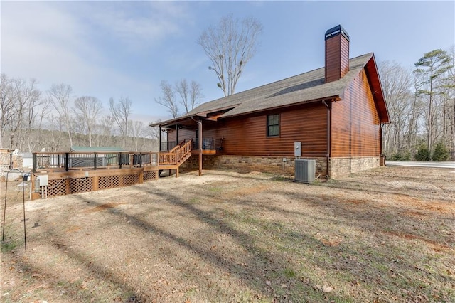 rear view of house with central air condition unit and a deck