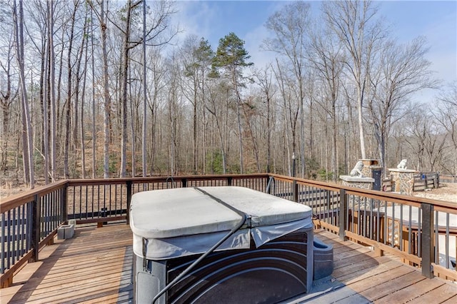 wooden terrace featuring a fireplace and a hot tub