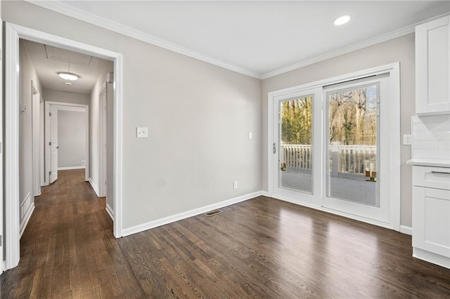 unfurnished dining area featuring ornamental molding and dark hardwood / wood-style flooring