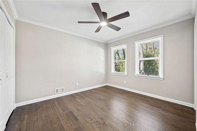 spare room with dark wood-type flooring, ornamental molding, and ceiling fan