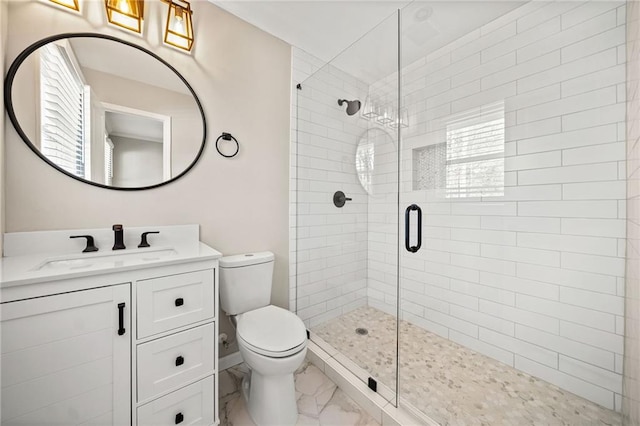 bathroom featuring vanity, a shower with shower door, and toilet