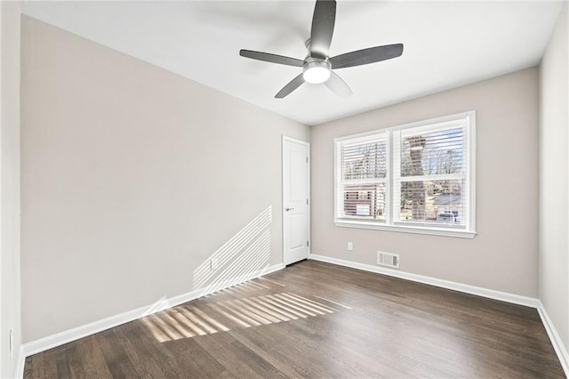 empty room featuring ceiling fan and dark hardwood / wood-style flooring