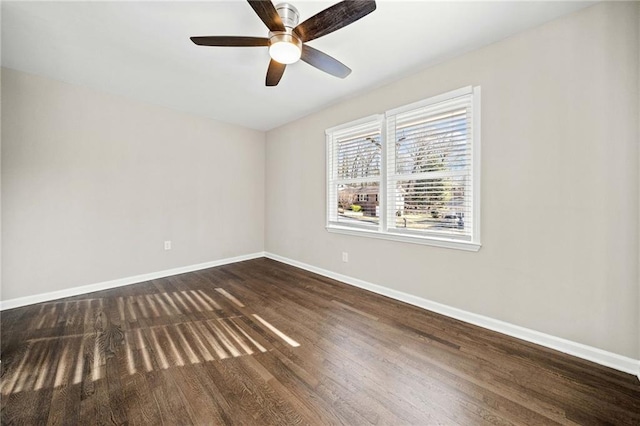 spare room with ceiling fan and dark hardwood / wood-style floors