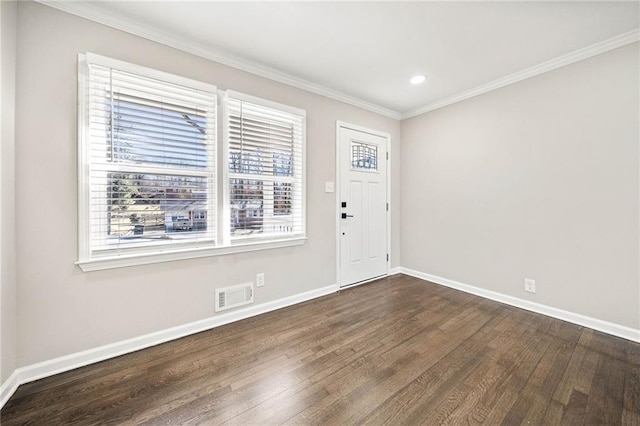 foyer entrance with crown molding and dark hardwood / wood-style flooring