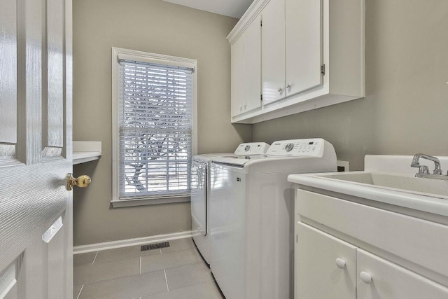 laundry area featuring visible vents, baseboards, cabinet space, tile patterned flooring, and washer and dryer