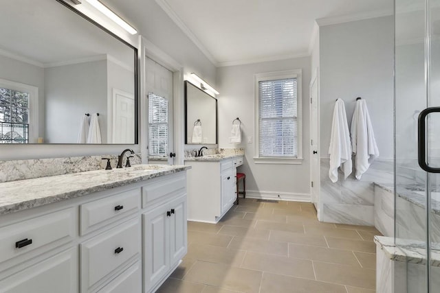 bathroom with two vanities, ornamental molding, and a sink