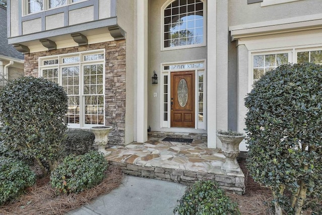 entrance to property with stucco siding and stone siding