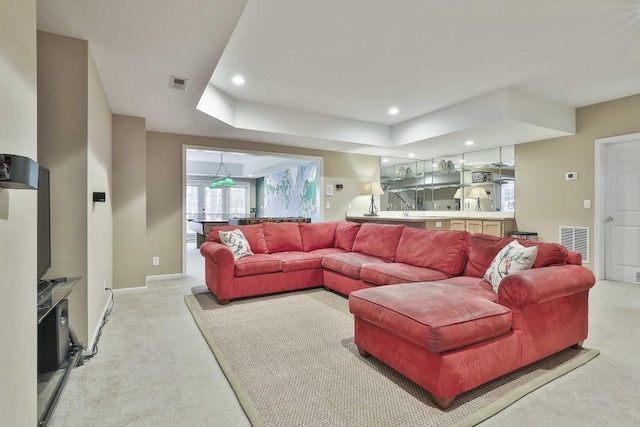 living room with light carpet, visible vents, and recessed lighting