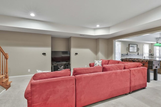 living room featuring stairs, recessed lighting, light colored carpet, and baseboards