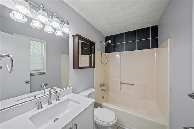 full bath featuring tub / shower combination, a textured ceiling, toilet, and vanity