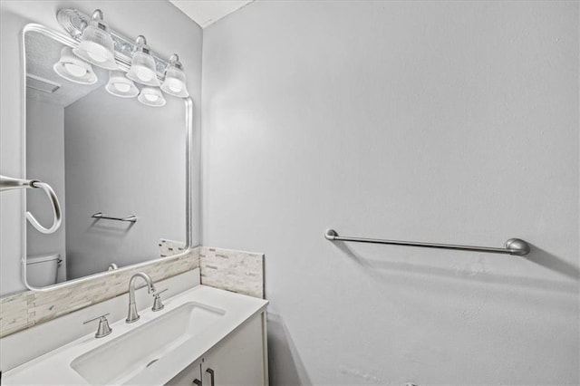 bathroom with toilet and vanity