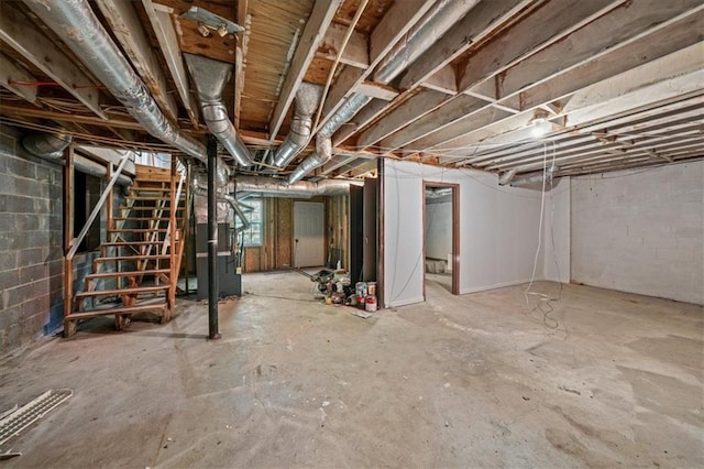 basement with stairway and concrete block wall