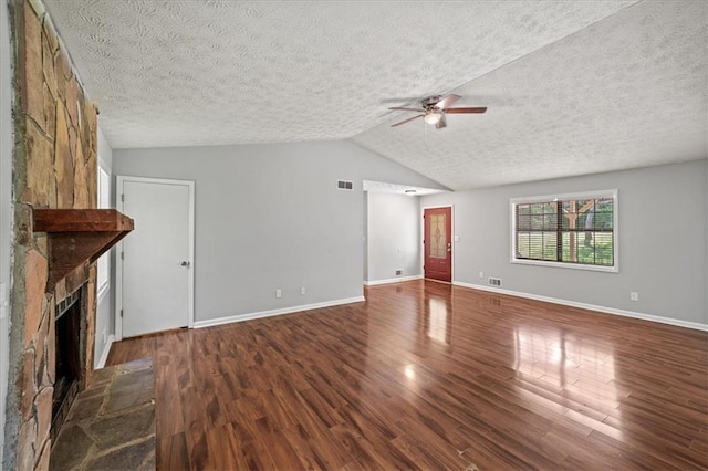 unfurnished living room with a textured ceiling, visible vents, a ceiling fan, wood finished floors, and a large fireplace