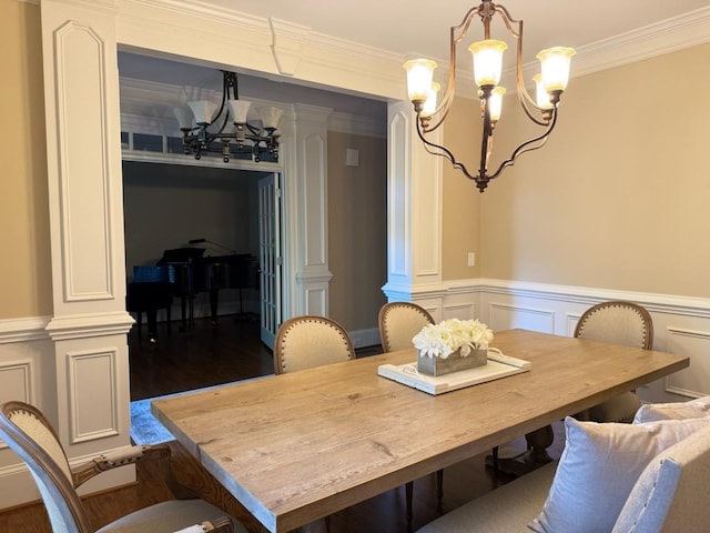 1984 Mendenhall Cir, Atlanta, GA 30341 - dining room featuring a chandelier, ornate columns, dark wood-style floors, crown molding, and a wainscoted wall
