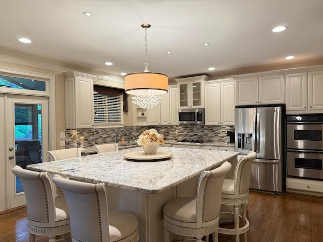 1984 Mendenhall Cir, Atlanta, GA 30341 - kitchen featuring stainless steel appliances, backsplash, a kitchen island, light stone countertops, and recessed lighting