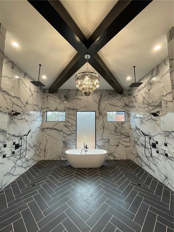 bathroom with beamed ceiling, plenty of natural light, shower with separate bathtub, and an inviting chandelier