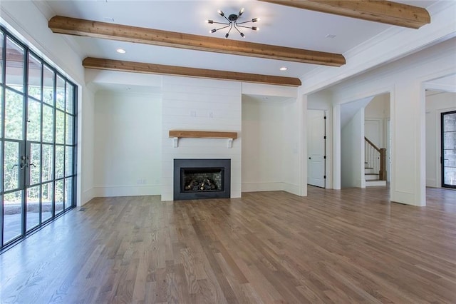 unfurnished living room with a fireplace, hardwood / wood-style flooring, and plenty of natural light