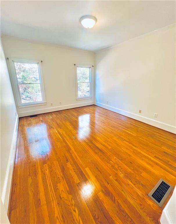 kitchen with crown molding, light wood-type flooring, and built in appliances