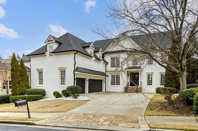 french provincial home with a garage