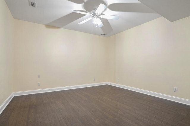 empty room with ceiling fan and dark wood-type flooring