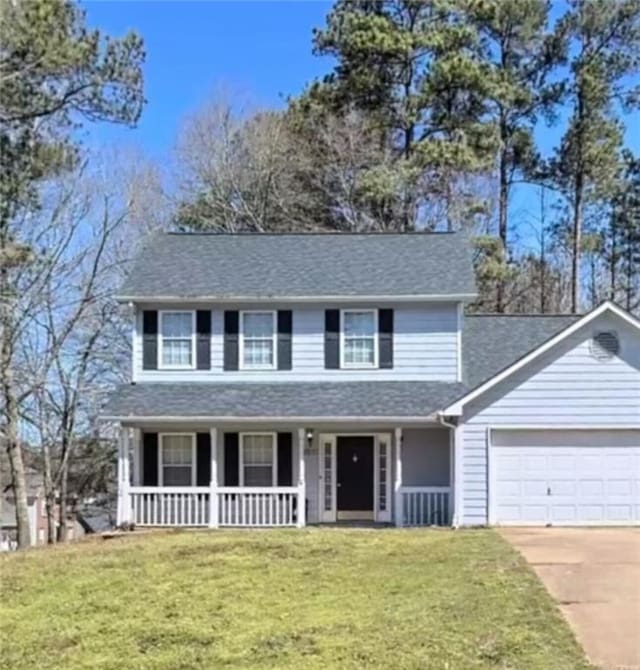 view of front of property featuring a garage, covered porch, and a front lawn