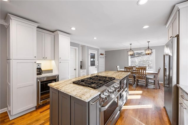 kitchen with white cabinets, recessed lighting, light wood-type flooring, and appliances with stainless steel finishes