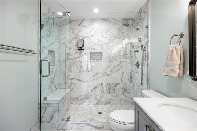 full bathroom with vanity, toilet, and a marble finish shower