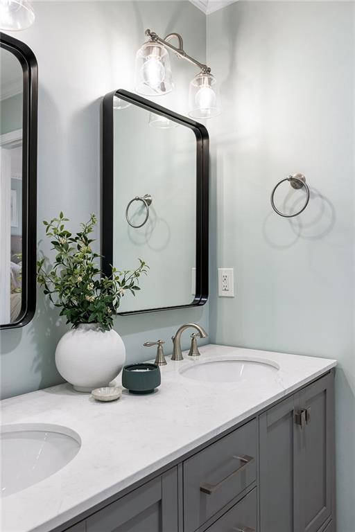 bathroom with a sink and double vanity