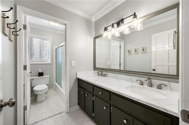 bathroom featuring ornamental molding, toilet, double vanity, and a sink