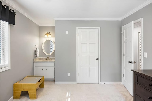 bathroom featuring baseboards, vanity, and crown molding