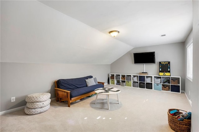 sitting room featuring lofted ceiling, carpet, visible vents, and baseboards