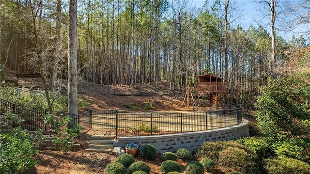 view of yard with fence and a view of trees