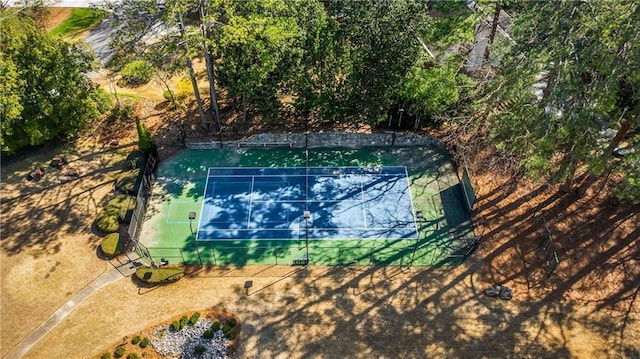 exterior space featuring a tennis court and fence