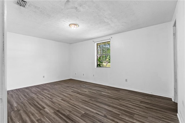 315 Pleasant Grove Rd, Mcdonough, GA 30252 - spare room with dark wood finished floors, a textured ceiling, and baseboards