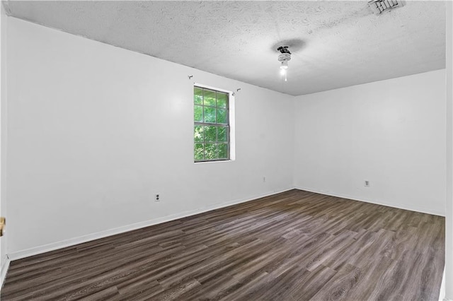 315 Pleasant Grove Rd, Mcdonough, GA 30252 - spare room with dark wood finished floors, a textured ceiling, and baseboards