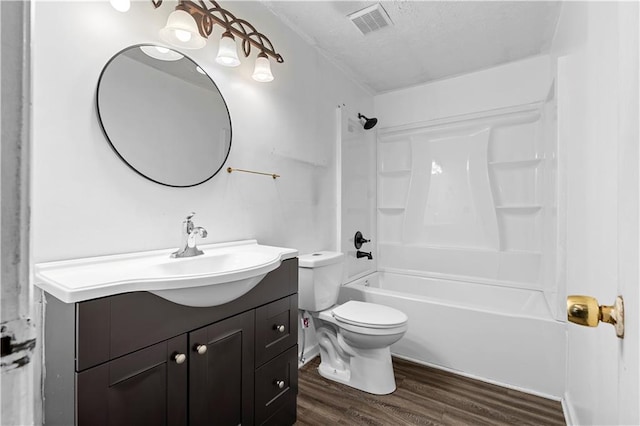 315 Pleasant Grove Rd, Mcdonough, GA 30252 - full bath featuring vanity, wood finished floors, tub / shower combination, toilet, and a textured ceiling