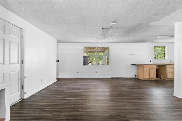 315 Pleasant Grove Rd, Mcdonough, GA 30252 - unfurnished living room with dark wood finished floors, a textured ceiling, and baseboards
