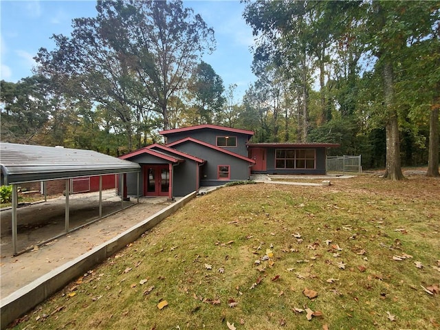 back of house with a yard and a carport